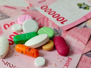 Colorful Pills on Indonesian Rupiah Banknotes: Healthcare Costs in Indonesia