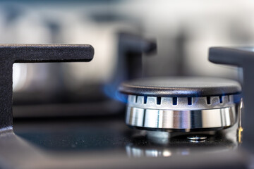 Modern gas burner. Blue flame. Macro technical detail.