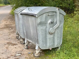 Trash cans in the park with garbage 