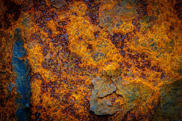 Rusty metal surface with shabby background paint. Blue cracked paint texture on an iron sheet....