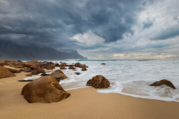 Dramatic Ocean Shoreline with Rocks and Stormy Sky