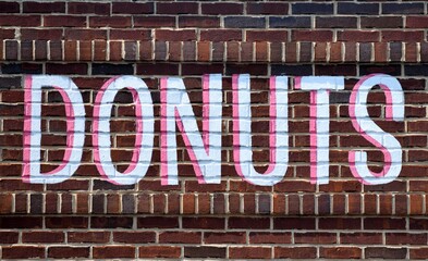 Donut sign on brick wall