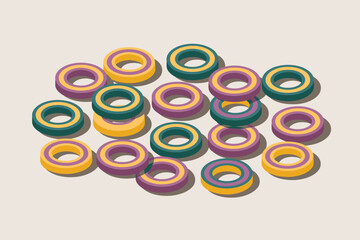 A collection of colorful ring shaped objects scattered on a light surface casting soft shadows around them