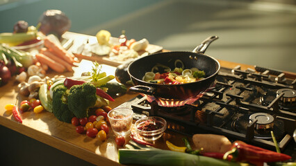 Chef cooking vegetables in wok on gas stove in kitchen