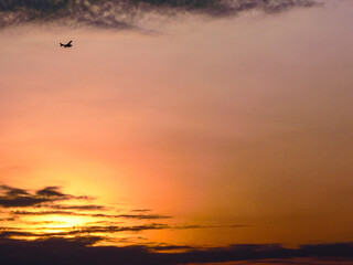 Airplane Silhouette in a Serene Sunrise Sky