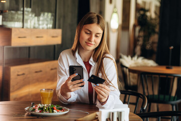 Young woman is in the cafe at daytime