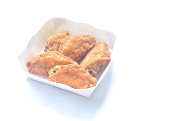 crispy fried salty chicken wing arranging in papay tray packaged on white background