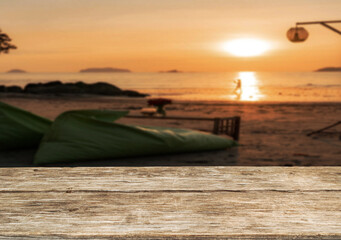 Wooden table top on the beach or sea.Party on the beach  sunset time concept.For montage product display or design key visual layout.View of copy space.