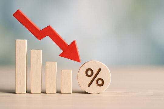 Economic recession and financial crisis are illustrated by stock market decline with red arrow pointing down over wooden blocks and percentage symbol showing falling rates
