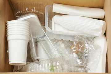 Sorting garbage for recycling. Used empty plastic containers, plastic bottles, plastic packaging in...