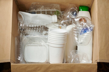 Sorting garbage for recycling. Used empty plastic containers, plastic bottles, plastic packaging in...