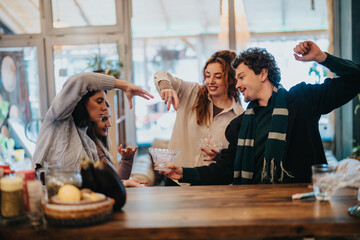 A group of friends share laughter and celebrate together while socializing indoors around a table, fostering a feeling of connection and joy.