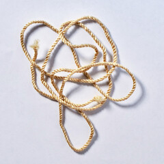 Thin short brown thread rope string object isolated on white colored background.