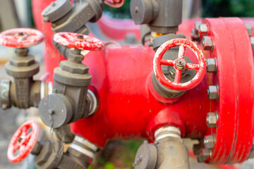 Intricate network of vibrant red industrial pipeline valves and connections system with metallic...