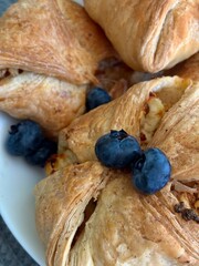 Close up of puff pastry with cheese filling and fresh blueberries. 
