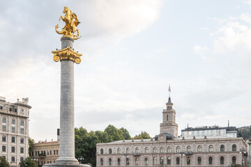 Iconic golden statue atop a column at Freedom Square in Tbilisi, Georgia. Monument celebrates Saint...