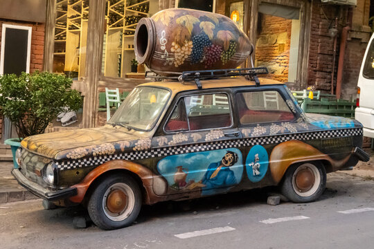 Tbilisi, Georgia - Sept 1, 2024: In Tbilisi, Georgia, a decorated ZAZ-968, a relic of the Soviet era, showcases Georgian wine culture, with a winemaking kvevri on top. 