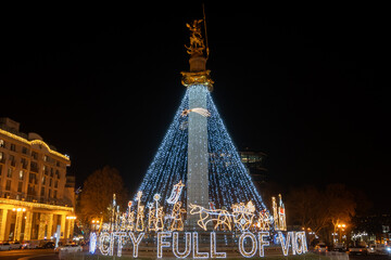 Illuminated Freedom Square monument honors Saint George and Georgia's independence, adorned with...