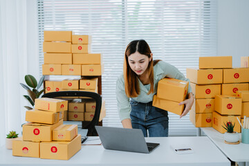 Starting small businesses SME owners female entrepreneurs check online orders to prepare to pack...