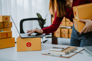 Starting small businesses SME owners female entrepreneurs check online orders to prepare to pack...