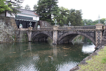 Fototapeta premium gate, bridge (seimon ishibashi), ramparts and moat at the imperial palace in tokyo in japan 