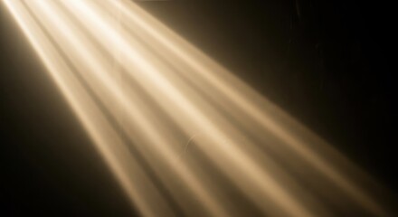 Golden light beams shining through darkness creating atmospheric effect