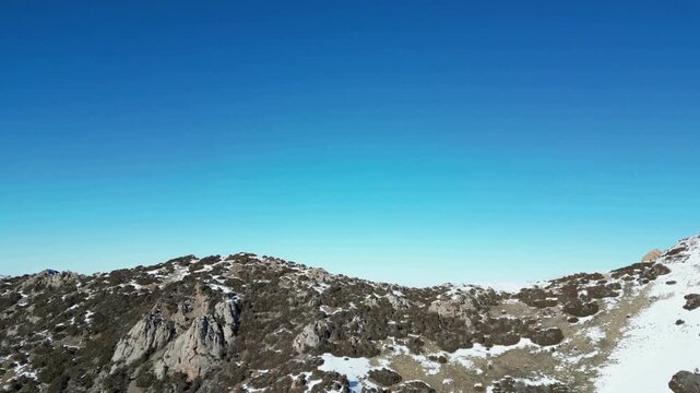 Flying on a drone, over the snow-capped peaks of the Sairam-Ugam National Park in the Republic of Kazakhstan, Shymkent. At an altitude of 2000 meters above sea level.