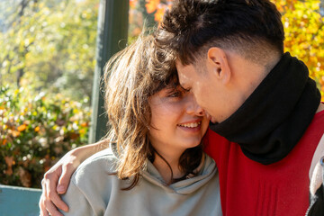 Young couple sharing an intimate moment in autumn park