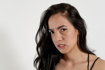 Young latin woman expressing anger and frustration on white background