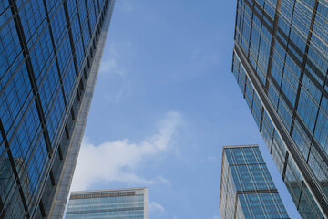 Low angle view of skyscraper with glass window and clear blue sky background for business and finance concept