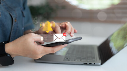 Close-up of hands using smartphone with email notification icon showing 37 new messages and bell alert symbol, representing online communication, business email marketing, and message reminder system.