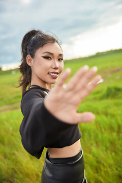 Asian women taking photos while traveling in the Bashang Grassland scenic area.