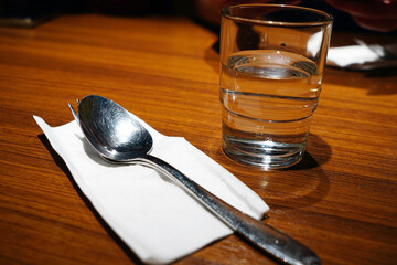 Cutlery, spoon and glass of water on the table