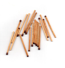 A small group of matches scattered in a loose pile.