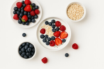 Flat Lay of Healthy Breakfast with Berries and Yogurt on White Background