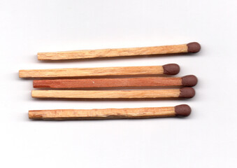 A close-up shot of five matches neatly stacked.