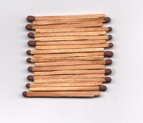 A symmetrical pattern of matches with the heads aligned.