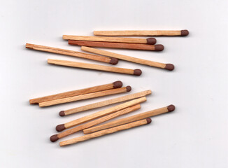 Multiple groupings of matches arranged in an abstract pattern.