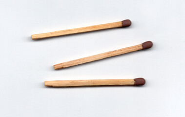 Three simple matches arranged horizontally on a white background.