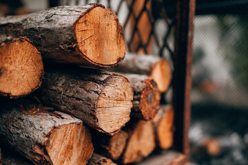 Firewood in smoker room for smoked food, Wooden log for charcoal making in kitchen, Firewood for cooking in backyard garden kitchen.