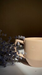 Cup of coffee with milk on a table in soft morning light. Cozy and calm atmosphere with warm tones and natural lighting.