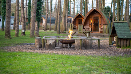 Camp camping glamping cabin pod fire nature wood forest holiday vacation travel retreat cozy evening flame log grass park leisure