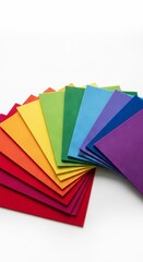 rainbow colored felt sheets fanned out on a solid white background