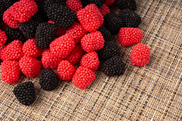 Gummy berries texture background, chewy raspberries close up, jelly blackberries pattern