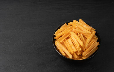 Fried chips sticks, finger potato chips, golden shoestring fries pile, French fries
