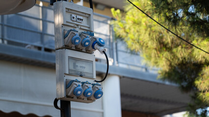 Outdoor electrical power distribution box with blue sockets