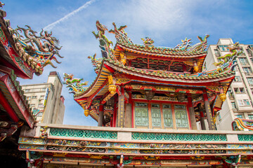 Fototapeta premium The view of Lungshan Temple in Taipei’s Wanhua District (also known as Monga) features traditional Chinese architecture with intricately carved wooden beams, colorful. 
