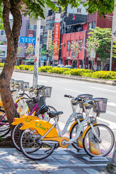 Taipei Taiwan 31st May 2025: A row of yellow-and-orange &ldquo;Ubike&rdquo; public sharing bicycles parked neatly along the sidewalk, offering locals and tourists an eco-friendly transport option. 