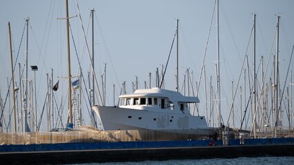 Fototapeta premium Luxury yacht in marina with sailboat masts