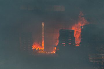 Fire in a storage warehouse. Everything is in smoke